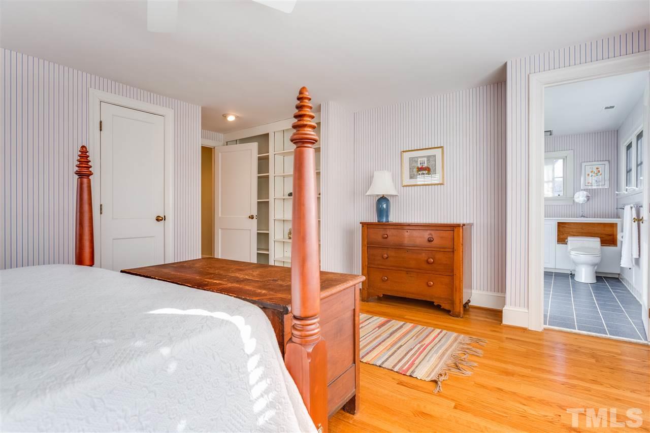 2514 Beechridge Road Raleigh, NC 27608 - Photo 19 of 25 a bedroom with a bed and wooden floor