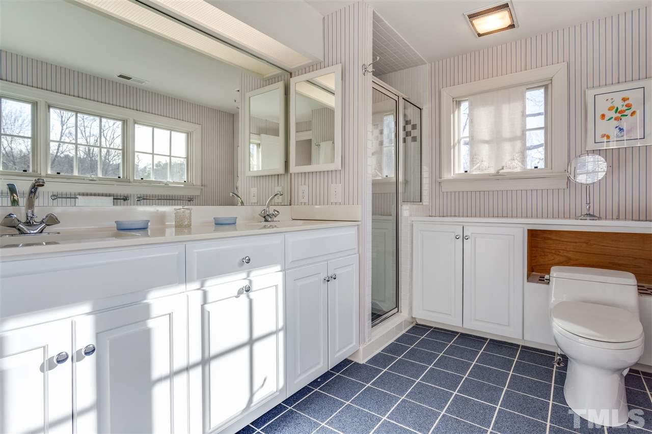 2514 Beechridge Road Raleigh, NC 27608 - Photo 20 of 25 a bathroom with a sink a toilet and a window