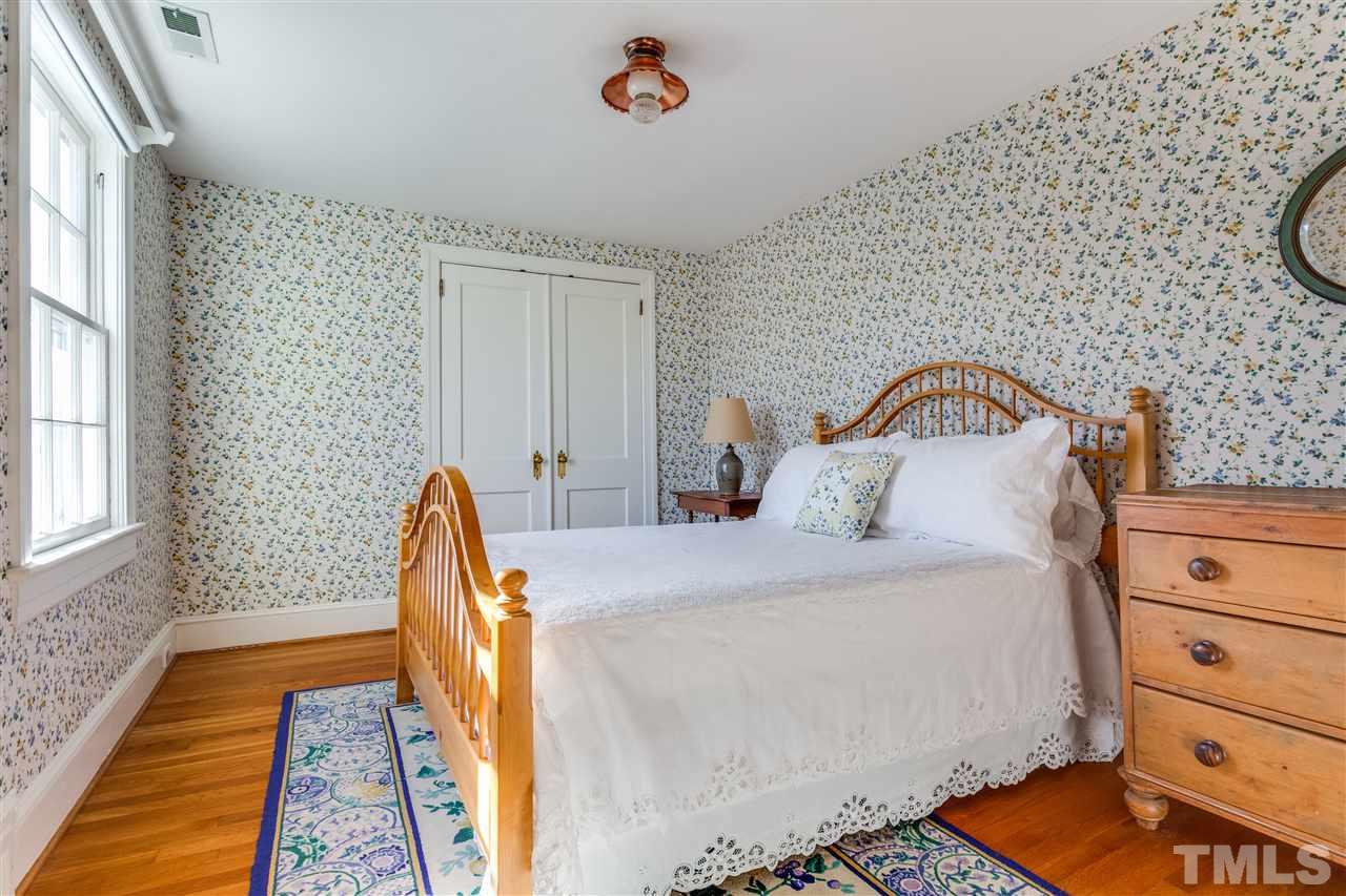 2514 Beechridge Road Raleigh, NC 27608 - Photo 21 of 25 a bedroom with a bed and wooden floor