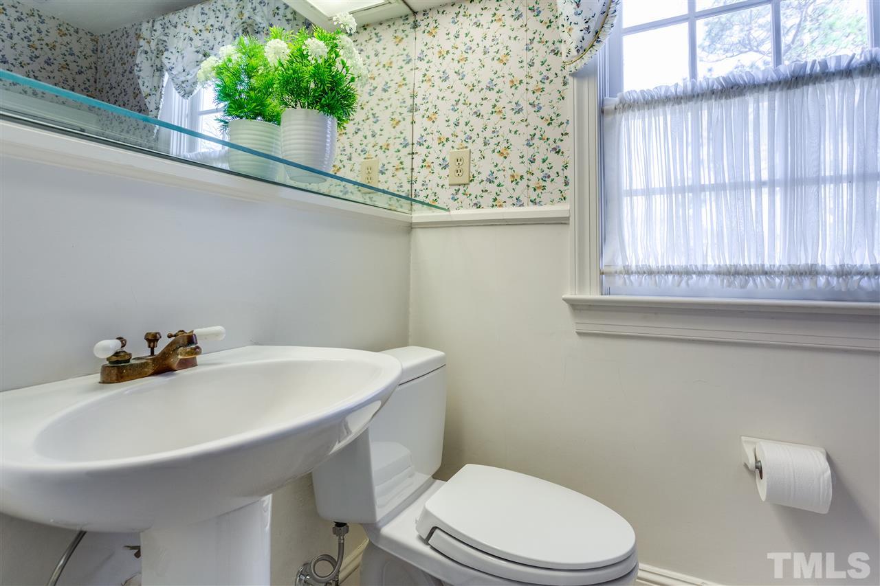 2514 Beechridge Road Raleigh, NC 27608 - Photo 22 of 25 a bathroom with a sink a toilet and a mirror