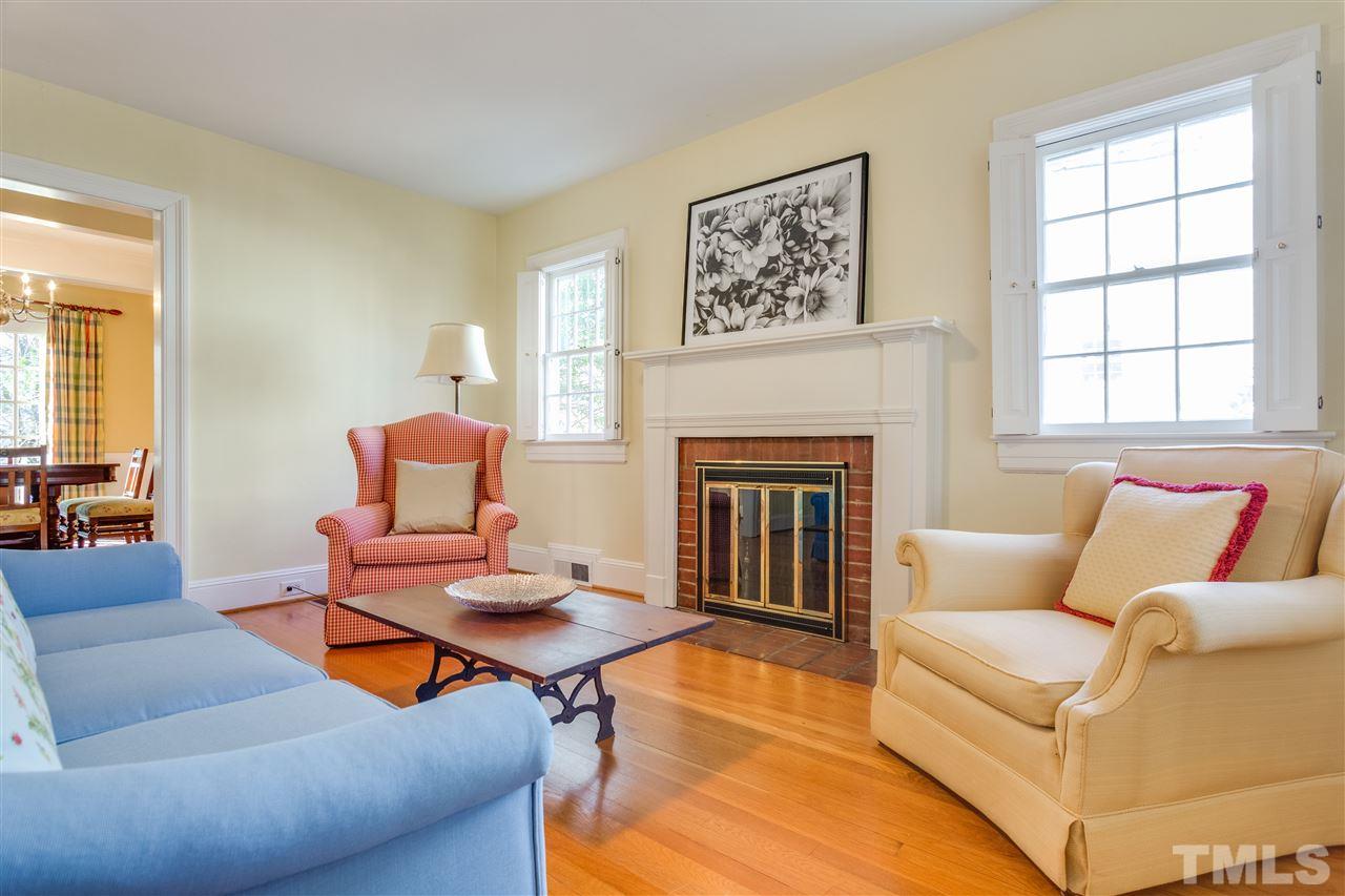 2514 Beechridge Road Raleigh, NC 27608 - Photo 10 of 25 a living room with furniture a fireplace and a window