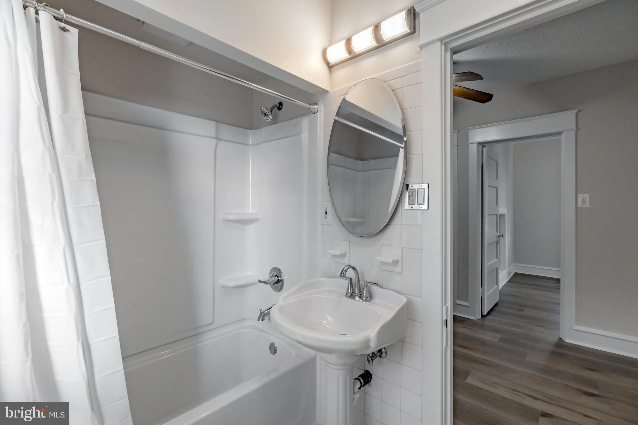 1210 West Darby Road Havertown, PA 19083 - Photo 14 of 33 a bathroom with a sink a mirror and a shower