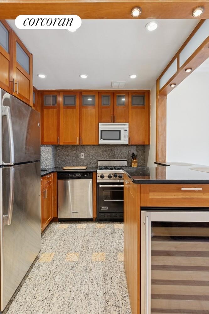 253 West 73rd Street, Unit 5O Manhattan, NY 10023 - Photo 2 of 11 a kitchen with stainless steel appliances granite countertop a stove a sink and a refrigerator