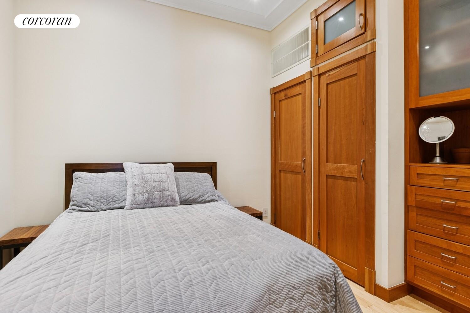 253 West 73rd Street, Unit 5O Manhattan, NY 10023 - Photo 5 of 11 a bedroom with a bed and cabinets