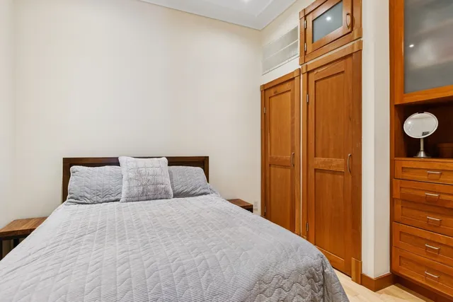 a bedroom with a bed and cabinets