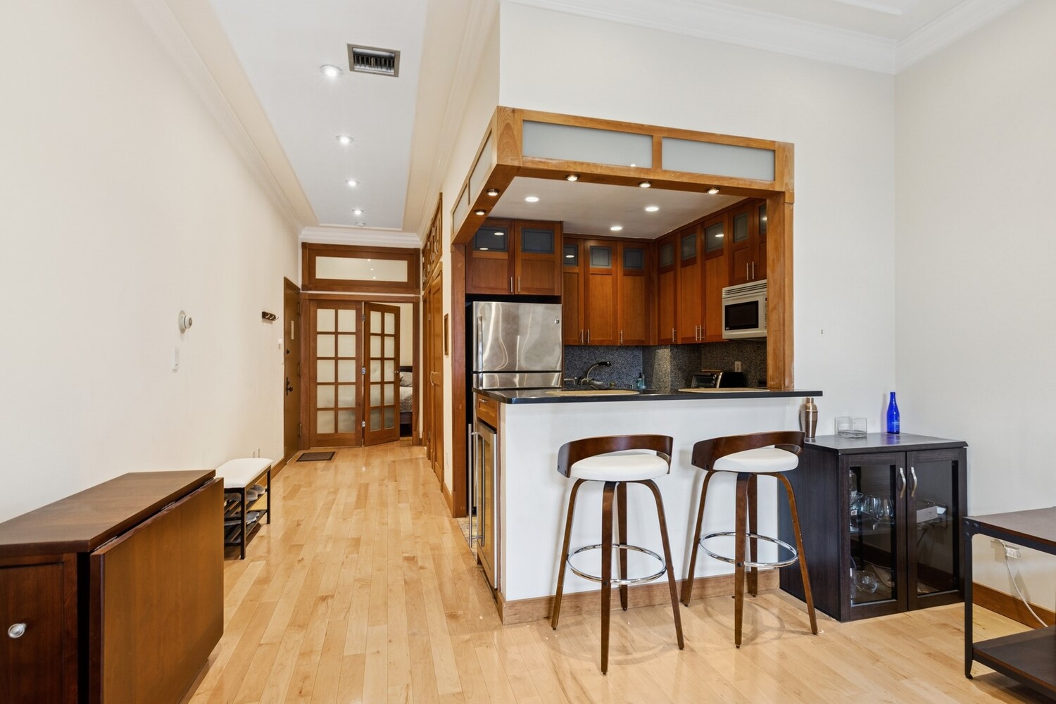 253 West 73rd Street, Unit 5O Manhattan, NY 10023 - Photo 8 of 11 a view of dining room kitchen with furniture and wooden floor