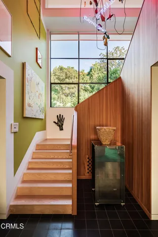 a large bedroom with a large bed and a large window with couch