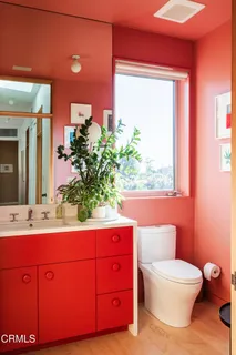 a living room with furniture a rug toys and a large window