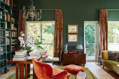 a living room with furniture toys and a book shelf