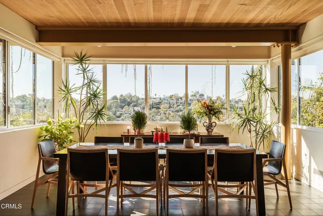 a kitchen with a sink a stove cabinets and wooden floor