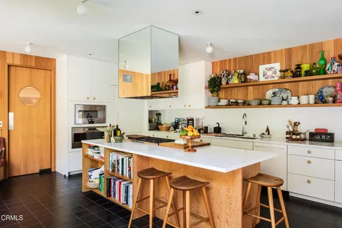 a kitchen with a sink a stove and cabinets