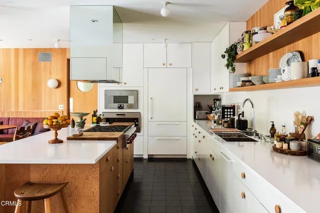 a kitchen with sink a stove and refrigerator