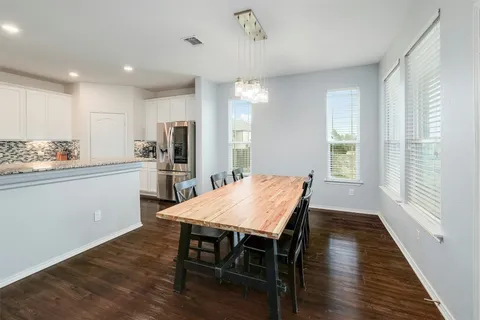 a large kitchen with stainless steel appliances granite countertop a sink and a stove
