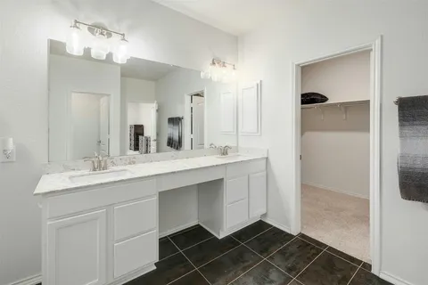 a bed room with a bed and a ceiling fan