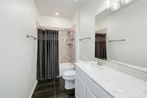 an empty room with furniture and a window