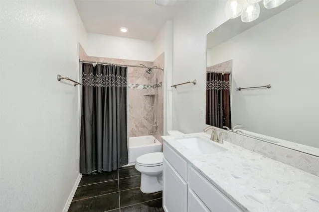 an empty room with furniture and a window