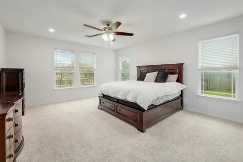 a bed sitting in a bedroom next to a window