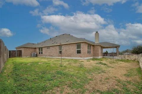 a large kitchen with a table and chairs