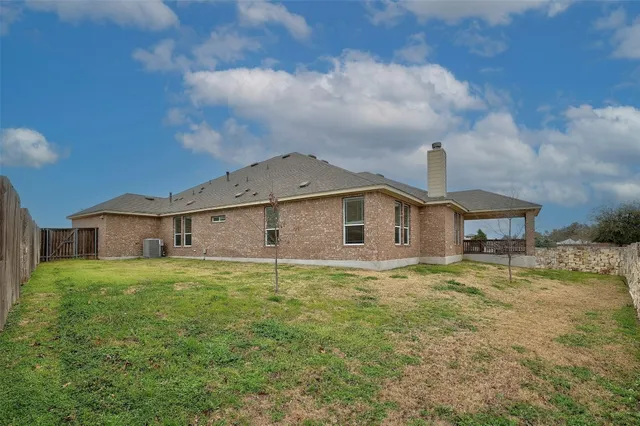a large kitchen with a table and chairs