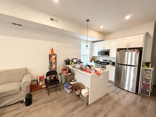 a view of a room with kitchen appliances and a couch