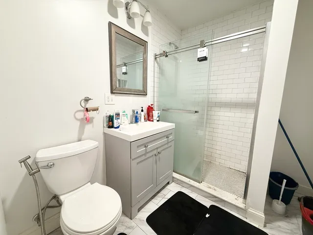 a bathroom with a sink toilet and shower