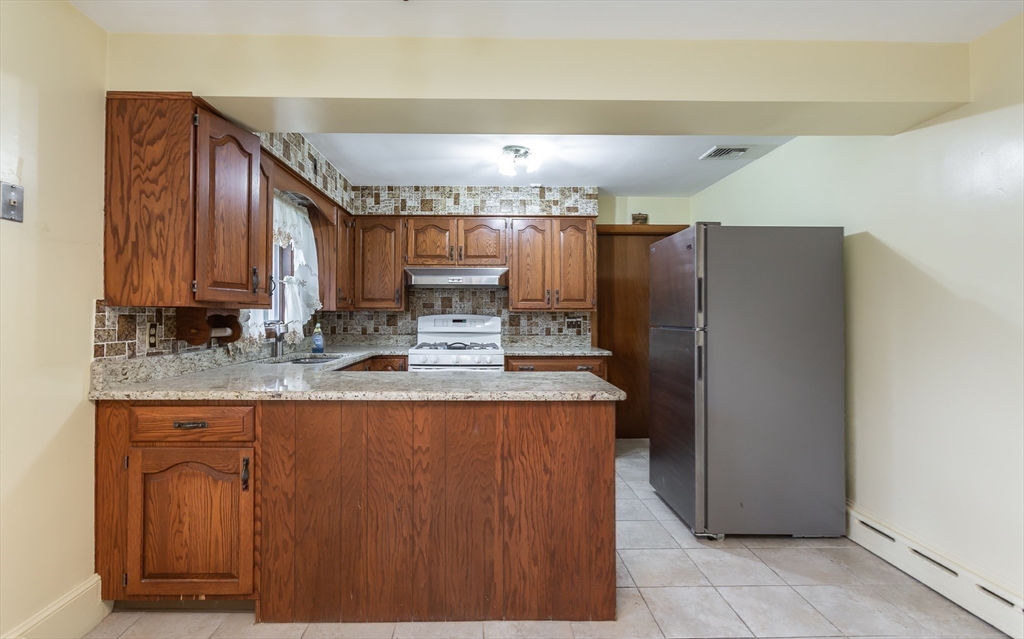 141 Kaufman Road Somerset, MA 02726 - Photo 12 of 26 a kitchen with stainless steel appliances granite countertop a refrigerator a sink and a stove