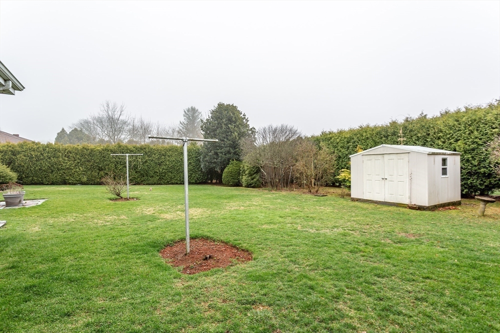 141 Kaufman Road Somerset, MA 02726 - Photo 3 of 26 a house with green field