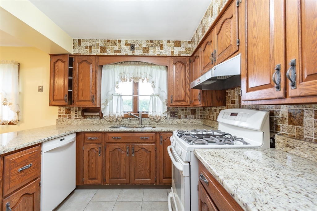 141 Kaufman Road Somerset, MA 02726 - Photo 10 of 26 a kitchen with a sink stove and cabinets