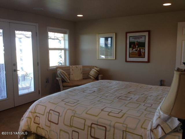 5305 Lombard Loop Road Zillah, WA 98953 - Photo 18 of 27 a bedroom with a bed and wooden floor