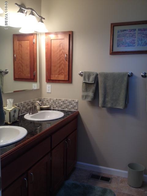 5305 Lombard Loop Road Zillah, WA 98953 - Photo 20 of 27 a bathroom with a granite countertop sink a mirror and a toilet