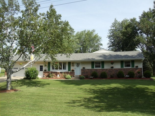 149 Swanson Road Sycamore, IL 60178 - Photo 1 of 22 a front view of a house with a garden and trees
