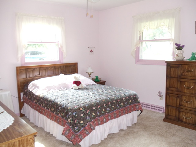 149 Swanson Road Sycamore, IL 60178 - Photo 11 of 22 a bed sitting in a bedroom next to a window