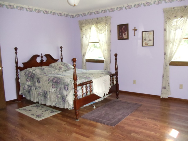149 Swanson Road Sycamore, IL 60178 - Photo 13 of 22 a bed room with a bed and a window