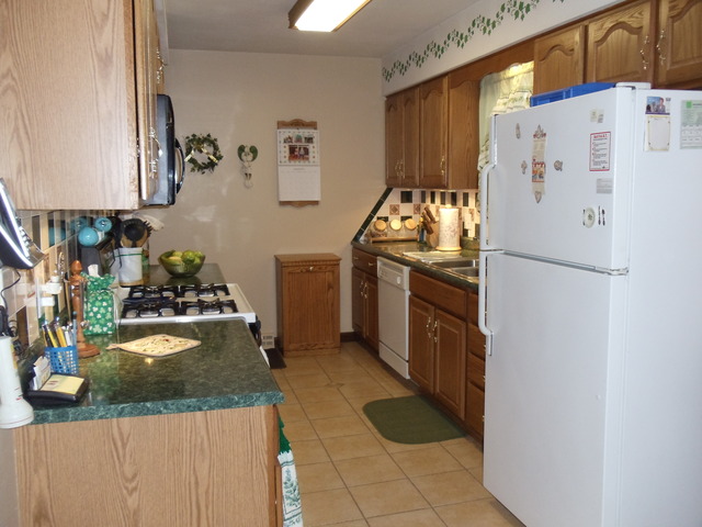 149 Swanson Road Sycamore, IL 60178 - Photo 5 of 22 a kitchen with granite countertop a refrigerator and a stove