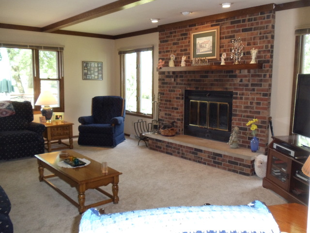149 Swanson Road Sycamore, IL 60178 - Photo 9 of 22 a living room with furniture a flat screen tv and a fireplace