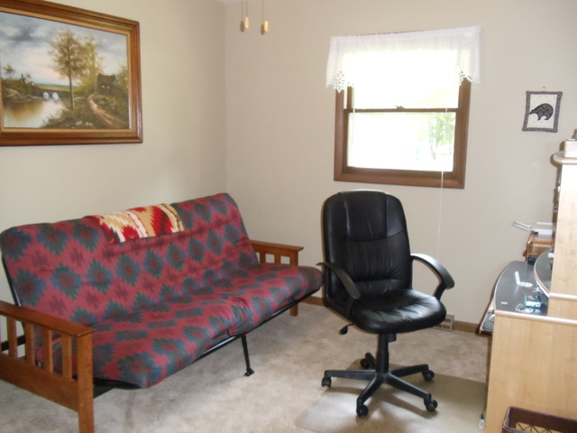 149 Swanson Road Sycamore, IL 60178 - Photo 10 of 22 a bedroom with a bed and chair