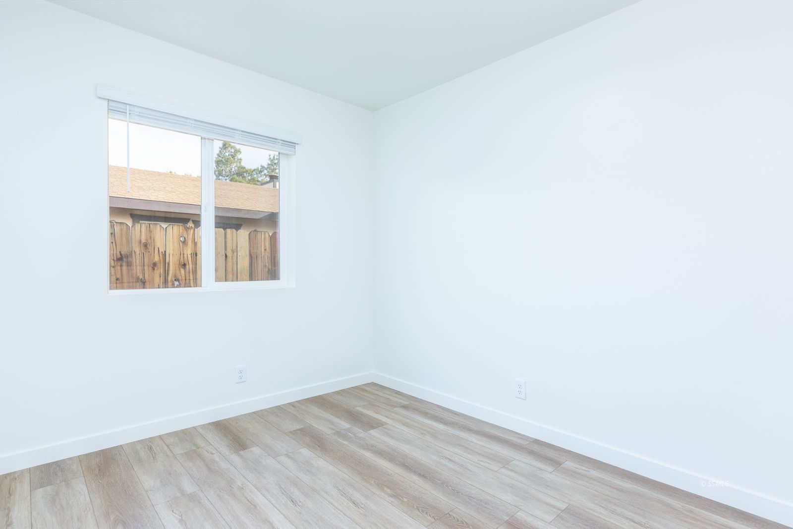 916 West Atkins Avenue Ridgecrest, CA 93555 - Photo 15 of 20 a view of an empty room with wooden floor and a window