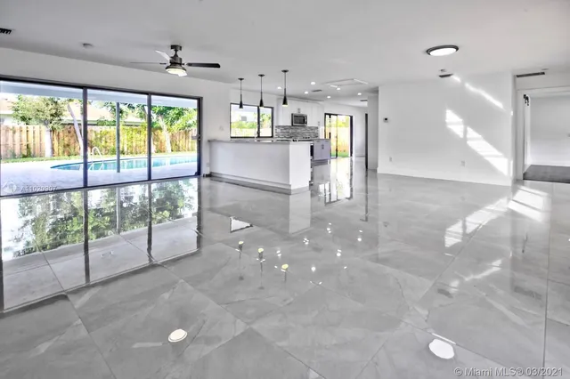 a view of a kitchen with large windows and a fireplace
