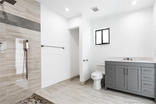 a bathroom with a toilet sink and a shower