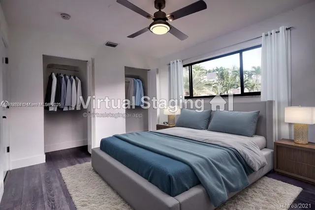 a bedroom with a large bed a chandelier and a window