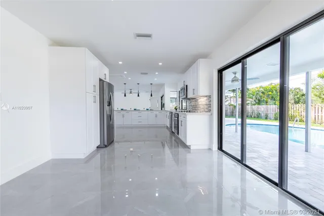 a kitchen with stainless steel appliances granite countertop a refrigerator and a sink