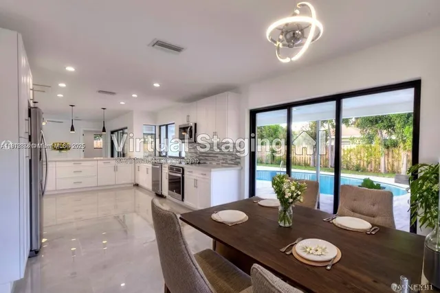 a open dining room with kitchen island furniture a large window and kitchen view
