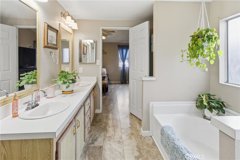 7156 North Winton Way Winton, CA 95388 - Photo 13 of 27 a bathroom with a tub sink and mirror