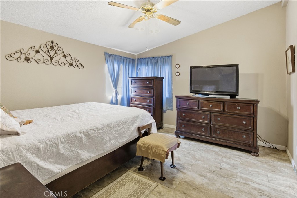 7156 North Winton Way Winton, CA 95388 - Photo 15 of 27 a bedroom with a bed and flat screen tv