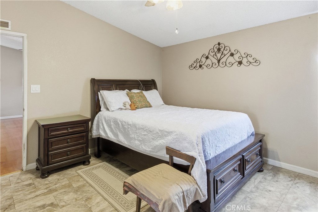 7156 North Winton Way Winton, CA 95388 - Photo 16 of 27 a spacious bedroom with a bed and a table in it