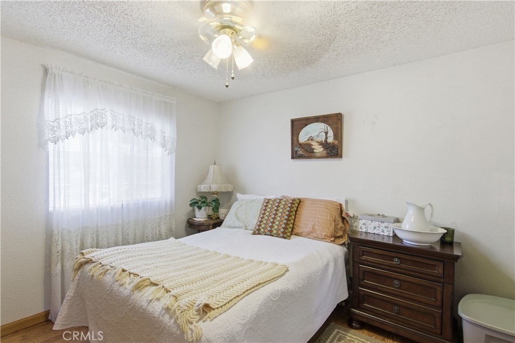 7156 North Winton Way Winton, CA 95388 - Photo 17 of 27 a bedroom with a bed and a chandelier