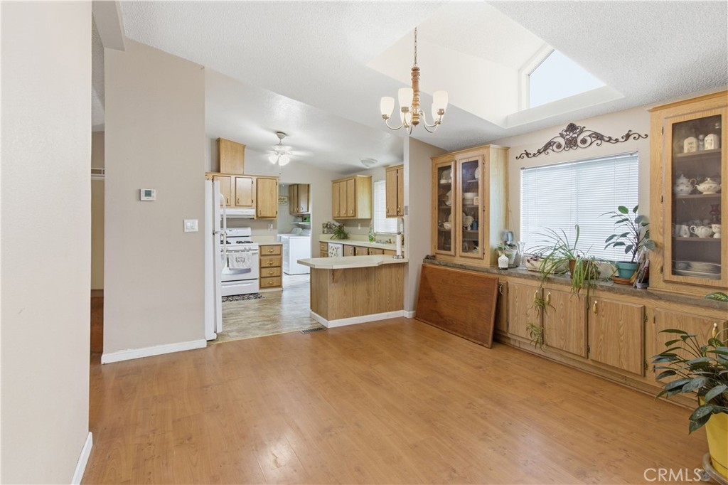 7156 North Winton Way Winton, CA 95388 - Photo 3 of 27 a large kitchen with kitchen island a large counter top space a sink stainless steel appliances and cabinets