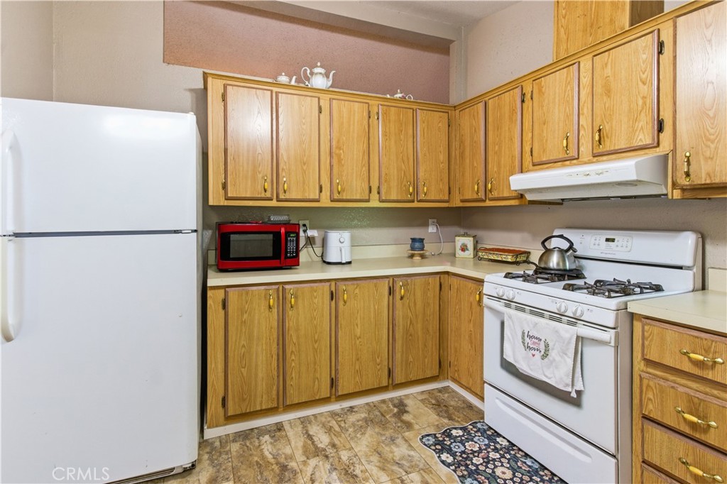 7156 North Winton Way Winton, CA 95388 - Photo 7 of 27 a kitchen with stainless steel appliances granite countertop a refrigerator sink and stove