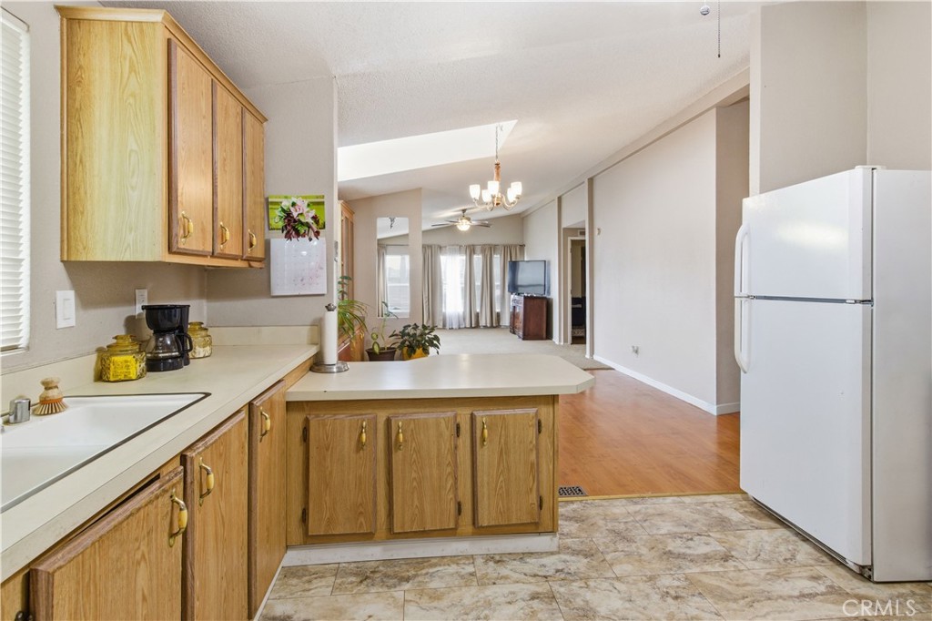 7156 North Winton Way Winton, CA 95388 - Photo 8 of 27 a kitchen with a sink a stove a refrigerator and a cabinets