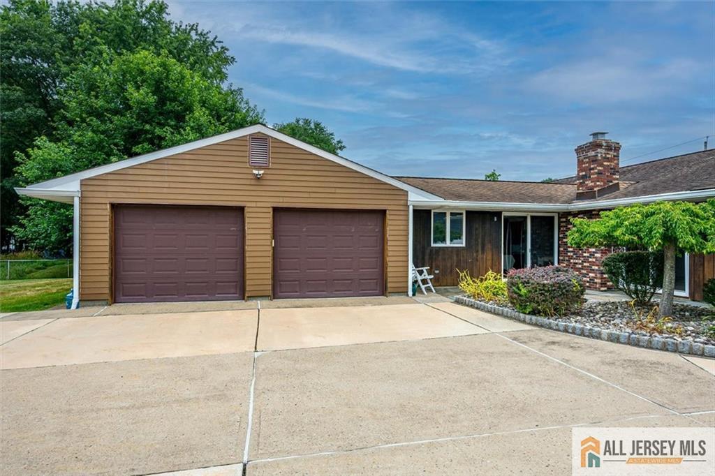21 Tyndall Road Kendall Park, NJ 08824 - Photo 24 of 33 a front view of a house with a yard and garage
